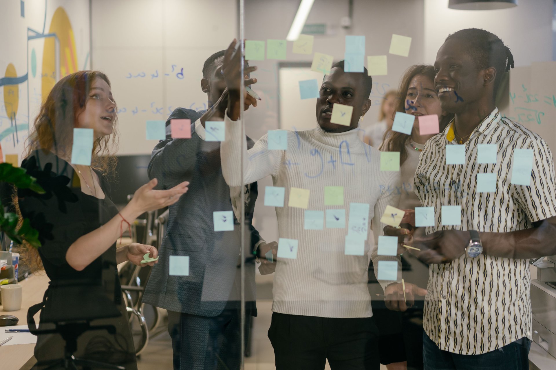 Colleagues collaborating with sticky notes during a feature breakdown session