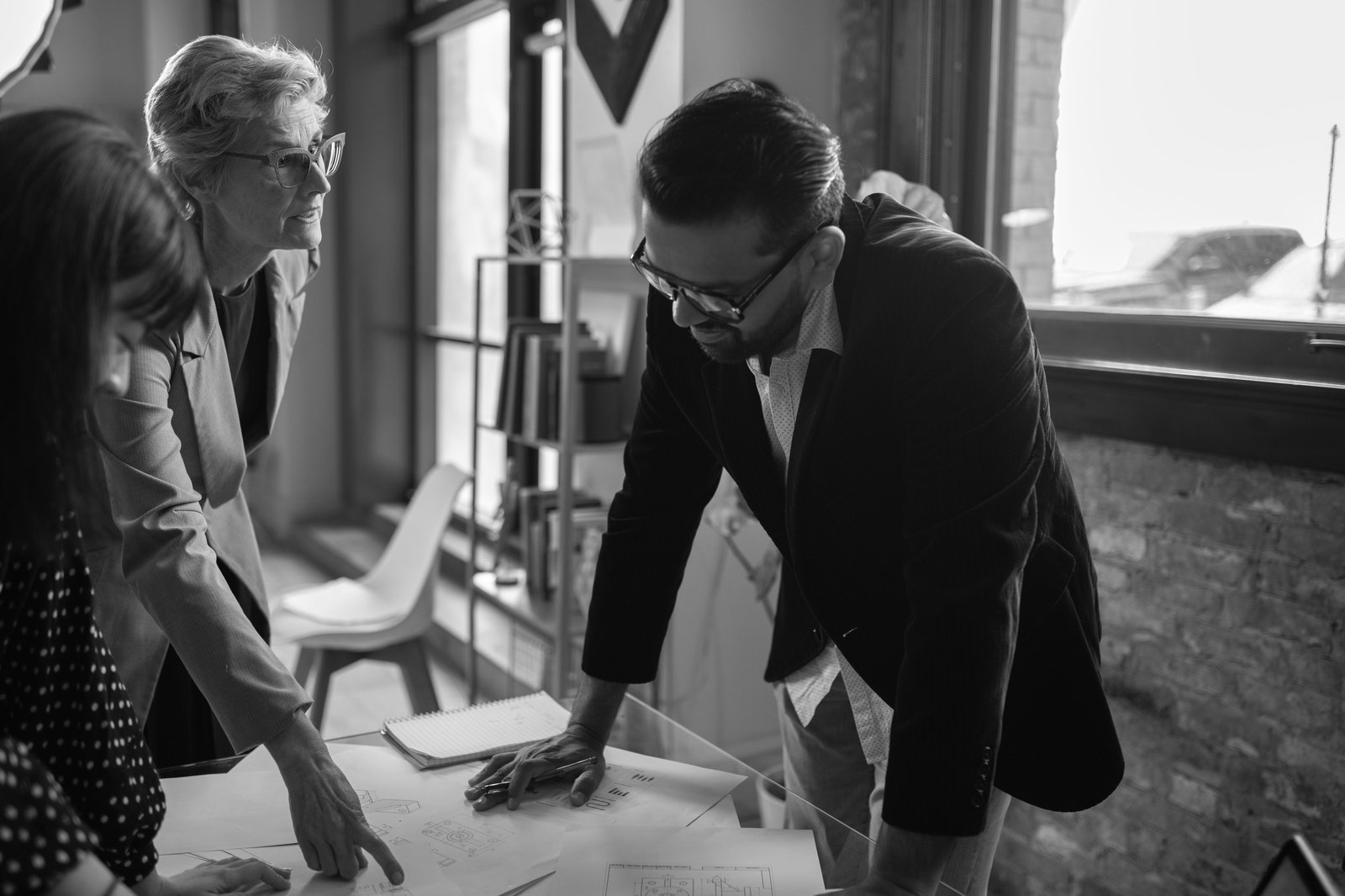 Senior leaders reviewing portfolio plans together in a bright loft office