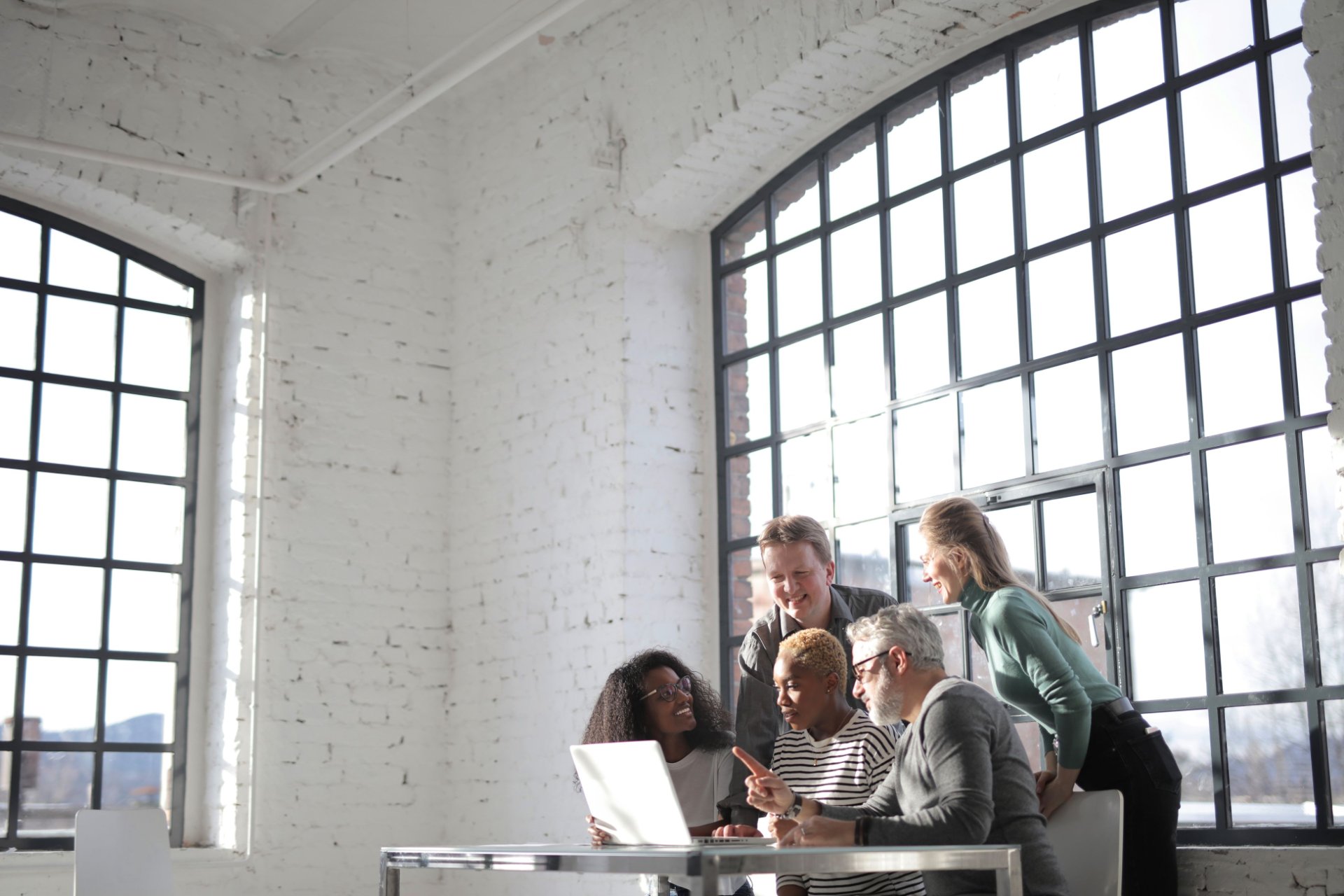 Team gathered around a table during a team chartering discussion
