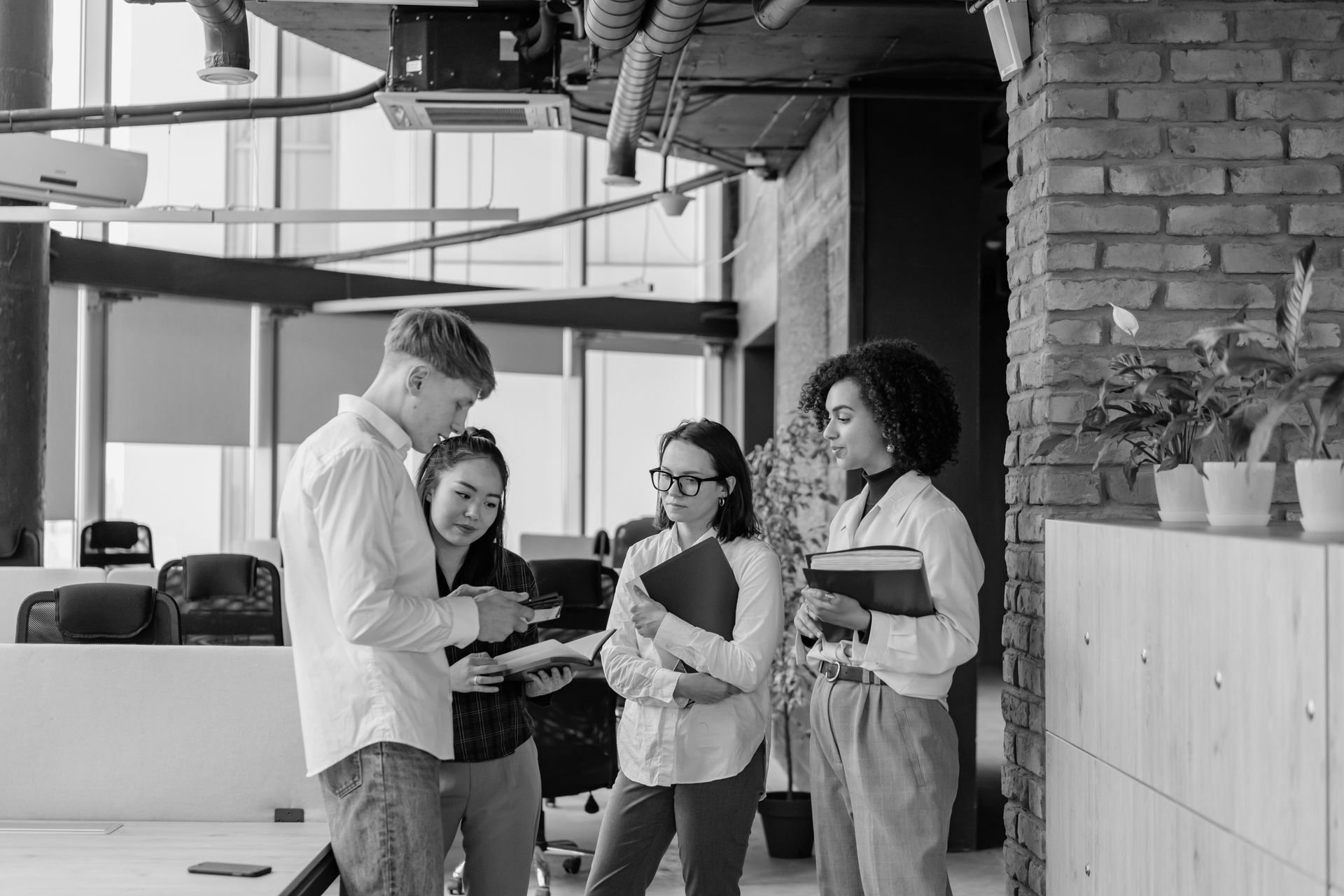 Colleagues reviewing documents together in a collaborative loft office space